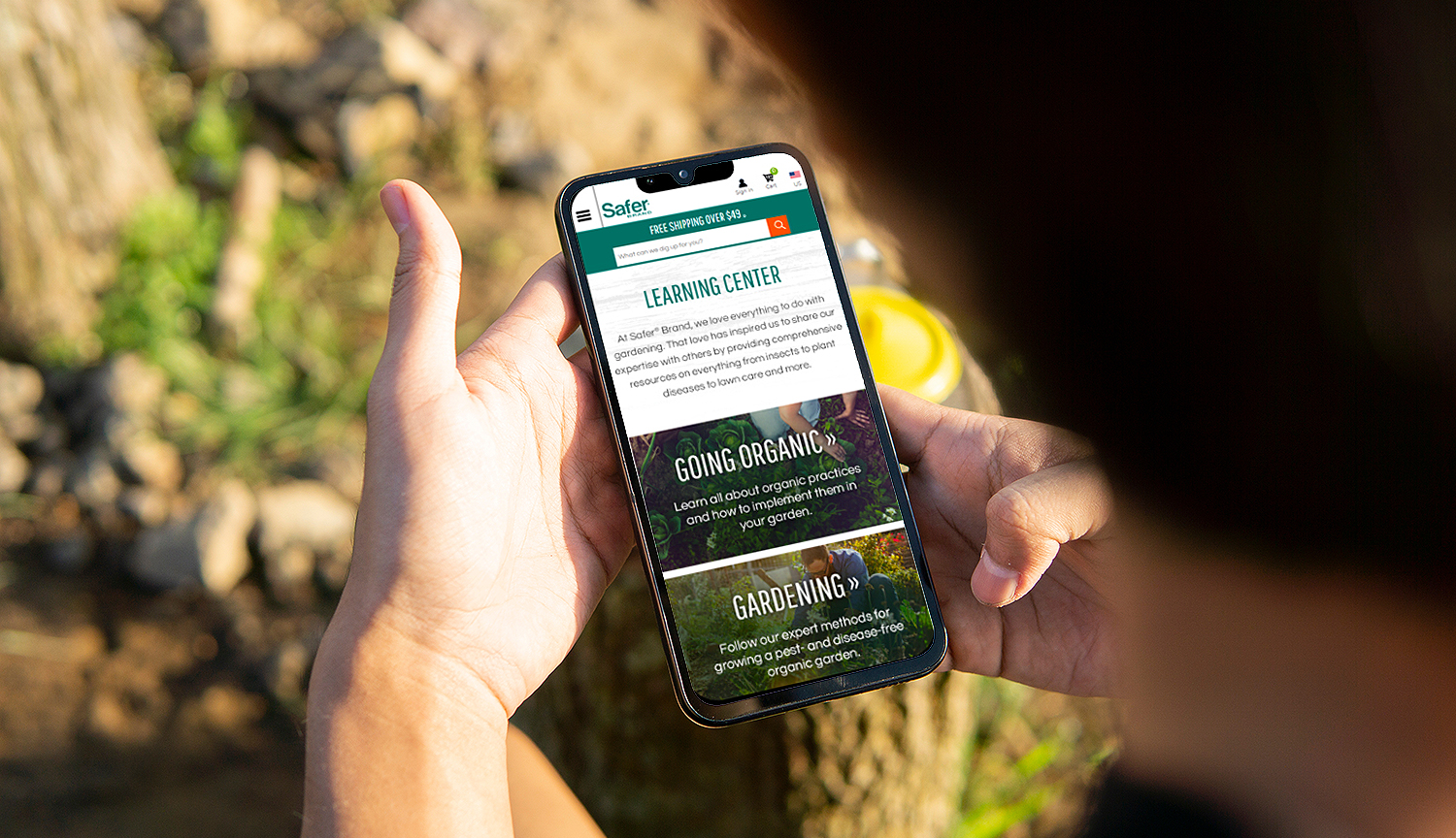 Mockup image of a man holding a smartphone with a blank screen f
